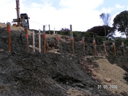 Slopes and new sea wall were stabilised using 110 bored piles reinforced by steel tubes - and in some cases beams, and also using steel tube soil nails 